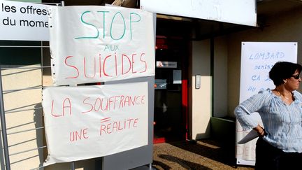 Une employée de France Télécom, devant l'entrée&nbsp;d'un bureau de l'entreprise, à Annecy-le-Vieux, où travaillait un salarié qui s'est suicidé, le 28 septembre 2009.&nbsp; (JEAN-PIERRE CLATOT / AFP)