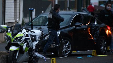 Des policiers inspectent le lieu où un&nbsp;automobiliste a volontairement percuté deux motards de la police, le 27 avril 2020 à Colombes (Hauts-de-Seine).&nbsp; (FRANCK FIFE / AFP)