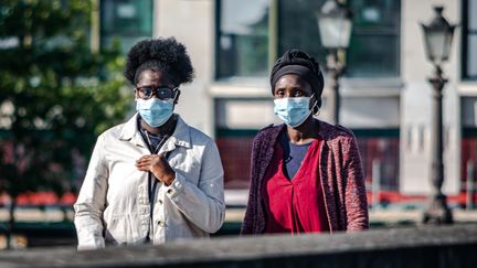 Des passantes portent un masque sanitaire à Paris, le 15 mai 2020. (LUDIVINE PELLISSIER / HANS LUCAS / AFP)