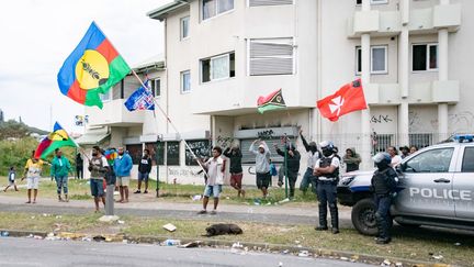Pro-independence activists wave Kanak flags as the Tuband College parents' association gathers to restore calm and reopen the school in Noumea, New Caledonia, on July 11, 2024. (DELPHINE MAYEUR / AFP)