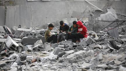 Children among destroyed buildings, in the Nuseirat refugee camp in Gaza, February 13, 2024. (ASHRAF AMRA / ANADOLU)