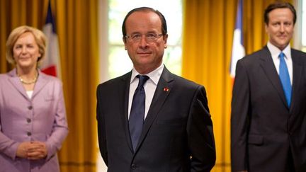 François Hollande en cire, entouré de Mme Merkel et de M.Cameron au Musée Tussauds de Londres.
 (Carl Court / AFP)