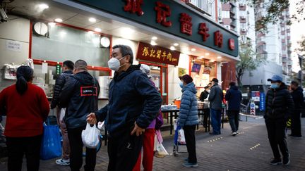 Des passants dans une rue de Pékin, malgré les restrictions sanitaires, le 22 novembre 2022. (MARK R. CRISTINO / EPA)