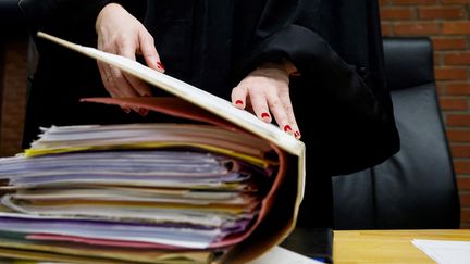 Un juge ouvre un dossier dans une salle d’audience du palais de justice de Bobigny (Seine-Saint-Denis), le 15 janvier 2024. (LUDOVIC MARIN / AFP)