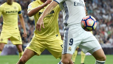 Karim Benzema, l'attaquant du Real Madrid, bien pris par le défenseur de Villarreal, Mateo Musacchio (GERARD JULIEN / AFP)