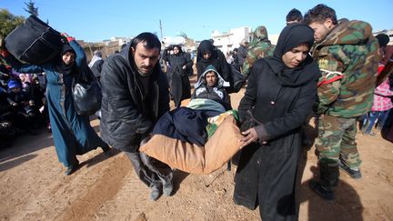 La population tente de se mettre à l'abri en Syrie, le 8 décembre. (YOUSSEF KARWASHAN / AFP)