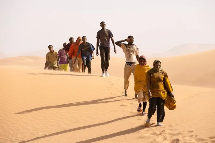 The march of migrants in the desert, image from the film 