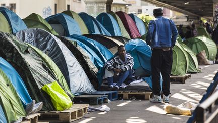 Deux migrants discutent dans un camps install&eacute; sous le m&eacute;tro La Chapelle, &agrave; Paris, le 1er juin 2015.&nbsp; (GEOFFROY VAN DER HASSELT / ANADOLU AGENCY / AFP)