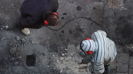 Des ouvriers travaillent au marteau piqueur sur une chaussée à Marseille. (PATRICE MAGNIEN / MAXPPP)