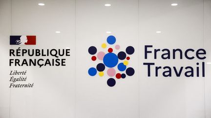 Le logo de "France Travail", le nouveau service public qui a succédé à "Pôle emploi", à côté de la devise de la République Française, à Paris, le 3 janvier 2024. (LUDOVIC MARIN / AFP)