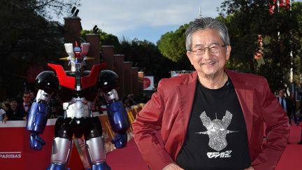 Go Nagai, père de Goldorak, pose devant une autre de ses créations, Mazinger Z,&nbsp;lancée en 1972, soit trois ans avant Goldorak,&nbsp;et qui a donné lieu à un film en 2017. La photo a été prise à Rome le 28 octobre 2017 lors de la présentation de ce film. (MARIA LAURA ANTONELLI / AGF / SIPA / MARIA LAURA ANTONELLI / AGF)