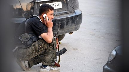 Un rebelle syrien passe un coup de fil apr&egrave;s avoir pris position &nbsp;&agrave; Alep, dans le nord de la Syrie, le 31 juillet 2012. (PIERRE TORRES / AFP)