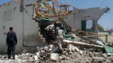 Un policier somalien sur les ruines d'un bâtiment attaqué par l'attentat suicide du 21 février, à Mogadiscio (AFP PHOTO / ABDURASHID ABDULLE ABIKAR)