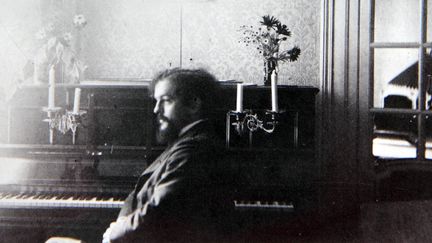 Claude Debussy assis au piano, chez son ami Lucien Fontaine, en août 1898
 (Collection Particuliere Tropmi / Manuel Cohen / AFP)