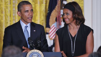 Barack et Michelle Obama, lors d'une conf&eacute;rence de presse &agrave; la Maison Blanche, &agrave; Washington (Etats-Unis), le 30 juin 2014.&nbsp; (MANDEL NGAN / AFP)