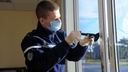 Un militaire&nbsp;recherche des&nbsp;empreintes sur une vitre à l'école de gendarmerie de Dinéault (Finistère), le 10 janvier 2014. (Illustration) (AFP)