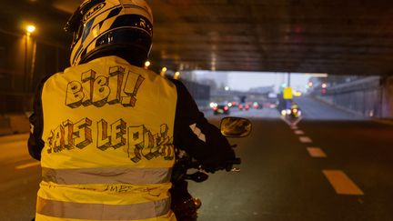 Un homme arbore un gilet jaune&nbsp;sur le périphérique parisien, le 17 novembre 2018. De nombreux motards se sont joints au mouvement national. (GREG LOOPING / HANS LUCAS)