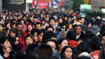 Un enfant sur les épaules de son père, le 28 janvier 2017, à Shanghai (Chine). (KE WEI / IMAGINECHINA / AFP)