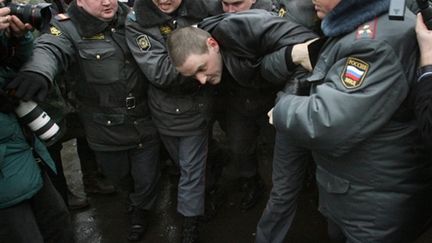 Un manifestant emmené par des policiers, place Pouchkine, à Moscou, le 20/03/2010 (AFP/Alexey Sazonov)