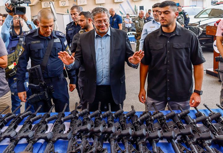 Le ministre de la Sécurité nationale israélien, Itamar Ben Gvir, devant des fusils d'assaut distribués à des groupes volontaires civils, le 27 octobre 2023 à Ashkelon (Israël). (HANNIBAL HANSCHKE / MAXPPP)