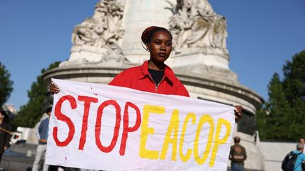 On June 23, 2023, an activist protests, Place de la République in Paris, against the EACOP project of Total Energies.  (THOMAS SAMSON / AFP)