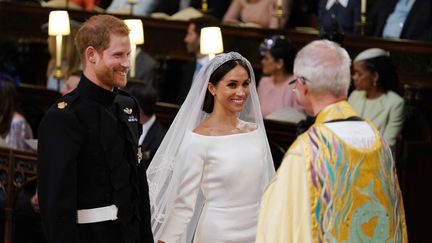 Le prince Harry et Meghan Markle lors de leur mariage, le 19 mai 2018 à Windsor (Royaume-Uni). (DOMINIC LIPINSKI / POOL / AFP)