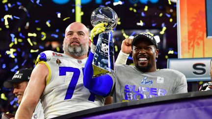 Les joueurs des Los Angeles Rams, Andrew Whitworth et&nbsp;Von Miller, soulèvent le Vince Lombardi Trophy après leur victoire lors du Super Bowl LVI contre les Cincinnati Bengals, le 13 février 2022 (FREDERIC J. BROWN / AFP)