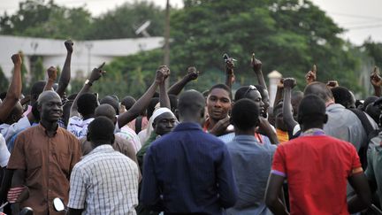 Des manifestants rassembl&eacute;s sur une place de Ouagadougou (Burkina Faso), o&ugrave; des membres de la garde pr&eacute;sidentielle retiennent le pr&eacute;sident et le Premier ministre. (AHMED OUOBA / AFP)