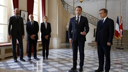 Emmanuel Macron à l'ambassade du Royaume-Uni à Paris, le 23 mai 2017, au lendemain de l'attentat qui a fait 22 morts à Manchester. Le président de la République est entouré de son Premier ministre Edouard Philippe, de ses ministres Jean-Yves Le Drian&nbsp;et Marielle de Sarnez et de l'ambassadeur Edward Llewellyn. (ETIENNE LAURENT / POOL)