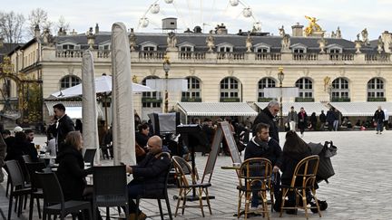 Des personnes en terrasse sur la place Stanislas avec une température de 14 degrés au thermomètre, le 1er janvier 2023. (MAXPPP)