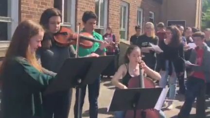 Des élèves de la&nbsp;Chetham School of Music chantent "Don't Look Back in Anger", le 23 mai 2017, à Manchester (Royaume-Uni). (ANA MARIA MARTINEZ NAVARRETE / FACEBOOK)