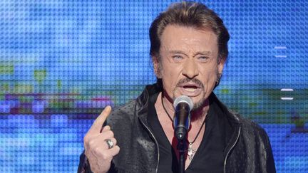 Johnny Hallyday participe au 26e T&eacute;l&eacute;thon, le 7 d&eacute;cembre 2012, &agrave; Saint-Denis (Seine-Saint-Denis). (BERTRAND GUAY / AFP)