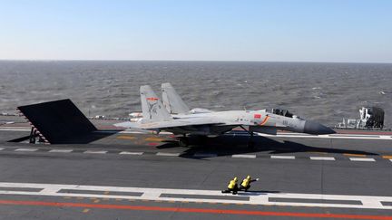 Un J-15 figther se prépare à décoller du porte-avions chinois "Liaoning", en décembre 2016. (STR / AFP)