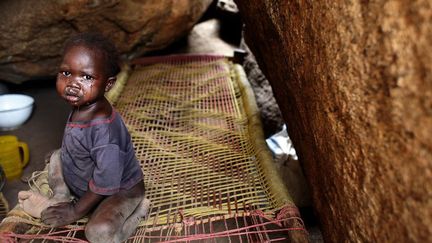 2 mai 2012. Un enfant pleure dans les rochers où il est abrité dans le village de Tess, dans la région des monts Nuba (Sud-Kordofan), au Soudan. Le territoire est aux mains des rebelles et les populations trouvent refuge dans les montagnes pour fuir les raids aériens de l'armée soudanaise. 
 (REUTERS/Goran Tomasevic)