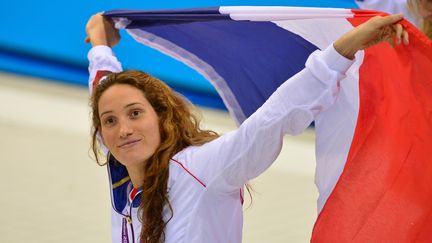 Camille Muffat c&eacute;l&egrave;bre son titre olympique au&nbsp;400 m nage libre, le 29 juillet 2012, aux Jeux olympiques de Londres (Royaume-Uni).&nbsp; (GABRIEL BOUYS / AFP)