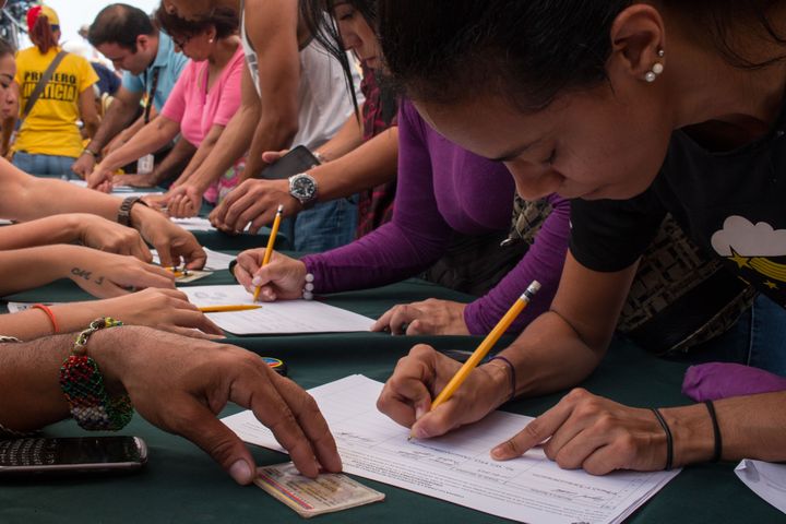 Des supporters de l'opposition vénézuélienne signent une pétition pour demander un référendum contre le président Nicolas Maduro, le 27 avril 2016.&nbsp; (CITIZENSIDE/ANDREA HERNANDEZ / CITIZENSIDE / AFP)