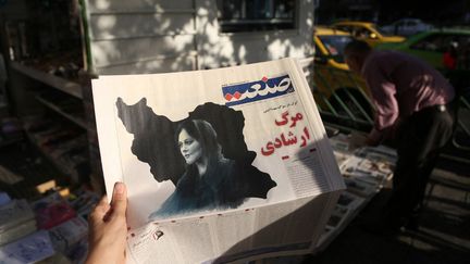 Un journal iranien annonce le 18 septembre 2022&nbsp;la mort de Mahsa Amini, 22 ans, décédée après avoir été arrêtée par la police des mœurs pour ne pas avoir respecté le code vestimentaire strict à Téhéran. (FATEMEH BAHRAMI / ANADOLU AGENCY / AFP)