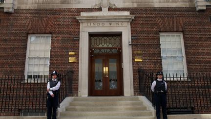 Des policiers gardent l'entr&eacute;e de l'h&ocirc;pital St Mary de Londres (Grande-Bretagne), o&ugrave; Kate a &eacute;t&eacute; admise pour accoucher, le 22 juillet 2013. (ANDREW COWIE / AFP)