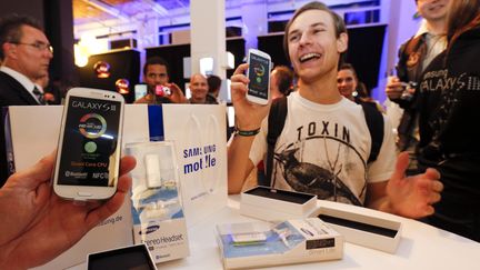 Des clients posent apr&egrave;s avoir achet&eacute; leur smartphone, le 28 mai 2012 &agrave; Berlin (Allemagne).&nbsp; (FABRIZIO BENSCH / REUTERS)