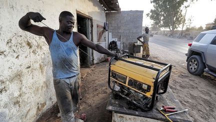 Un homme entretient un groupe électrogène dans un atelier à la périphérie de Tripoli. Les coupures de courant durent parfois la moitié de la journée. (MAHMUD TURKIA / AFP)