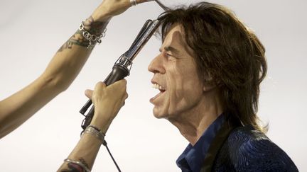 La coiffeuse du mus&eacute;e Gr&eacute;vin parisien apporte la touche finale &agrave; la statue de cire du chanteur des Rolling Stones Mick Jagger &agrave; Prague (R&eacute;publique tch&egrave;que), le 24 avril 2014. (DAVID W. CERNY / REUTERS)