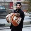 Un homme évacue un enfant d'Alep-Est (Syrie), le 12 décembre 2016.&nbsp; (ABDALRHMAN ISMAIL / REUTERS)