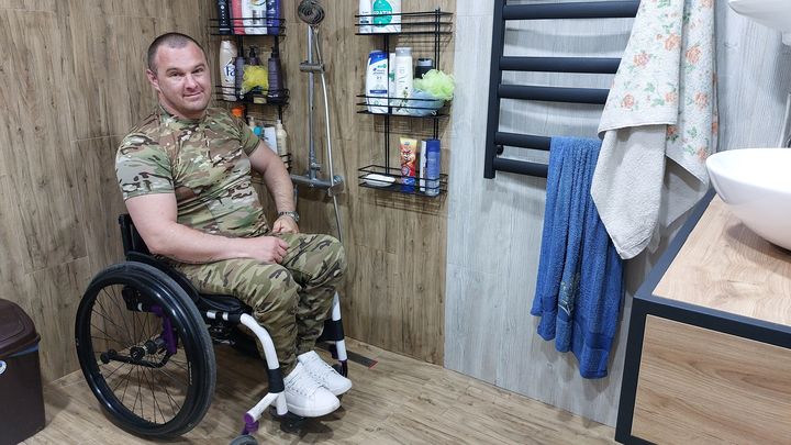 Oleksandr Popyk in his bathroom, redone by his wife and friends to fit his chair.  (AGATHE MAHUET)