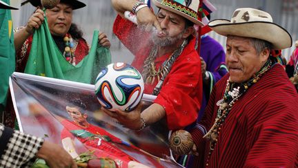 Des chamanes p&eacute;ruviens en plein rituel avec un ballon de la coupe du monde de football et un poster du joueur portugais Cristiano Ronaldo &agrave; Lima (P&eacute;rou), le 10 juin 2014. (ENRIQUE CASTRO-MENDIVIL / REUTERS)