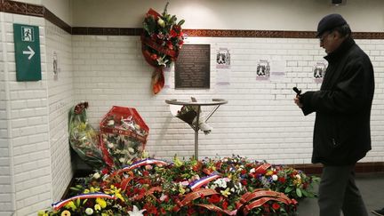 Un homme le 8 février 2013 devant une plaque commémorative au métro Charonne à Paris, où neuf personnes ont été tuées lors d'une manifestation&nbsp;pour la paix en Algérie le 8 février 1962. (PIERRE VERDY / AFP)