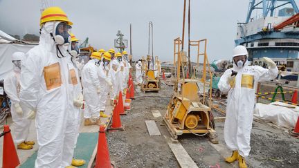 Des experts et des &eacute;lus en train d'inspecter les installations cens&eacute;es contenir les fuites d'eau radioactives, le 6 ao&ucirc;t 2013, &agrave; la centrale nucl&eacute;aire de Fukushima (Japon). (KYODO KYODO / REUTERS)