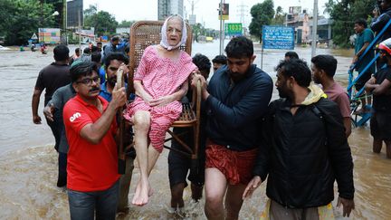 Des secouristes évacuent une femme âgée sur une chaise dans le district d'Ernakulam dans l'Etat du Kerala en Inde, le 17 août 2018.&nbsp; (AFP)