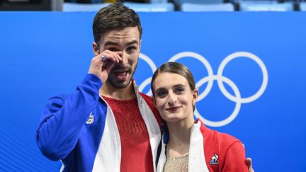 Gabriella Papadakis et Guillaume Cizeron réagissent après remporté la troisième médaille d'or française de ces Jeux olympiques de pékin, lundi 14 février 2022, en danse sur glace. (WANG ZHAO / AFP)