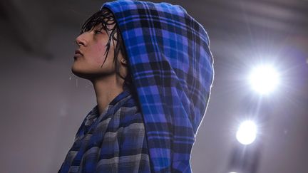 Chez le créateur Hiromichi Ochiai pour la marque japonaise Facetasm, la silhouette est oversize, les vêtements s'accumulent pour une allure streetwear colorée, "chaotique mais sophistiquée". Sur l'une des silhouettes féminines, la nuisette se superpose à une combinaison en doudoune noire. Ces jeunes urbains ont des marques sur les joues, qui font penser de loin à de l'acné ou à des traces laissées par l'oreiller, et portent parfois un masque sur la bouche.
 (CHRISTOPHE PETIT TESSON)