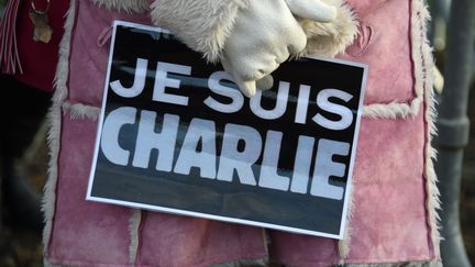 Une femme porte une affiche avec le slogan "Je suis Charlie", le 16 janvier 2015 à Pontoise (Val-d'Oise), lors des funérailles du dessinateur Charb. (DOMINIQUE FAGET / AFP)